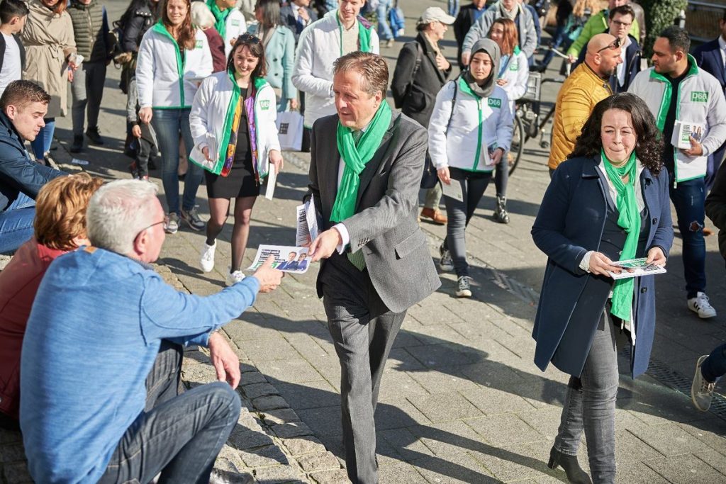 A picture of the Dutch party D66 delivering leaflets wearing matching scarfs